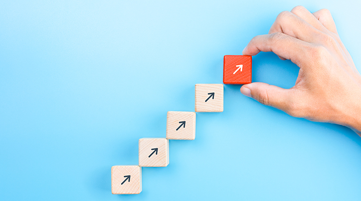 photo of hand placing blocks going up